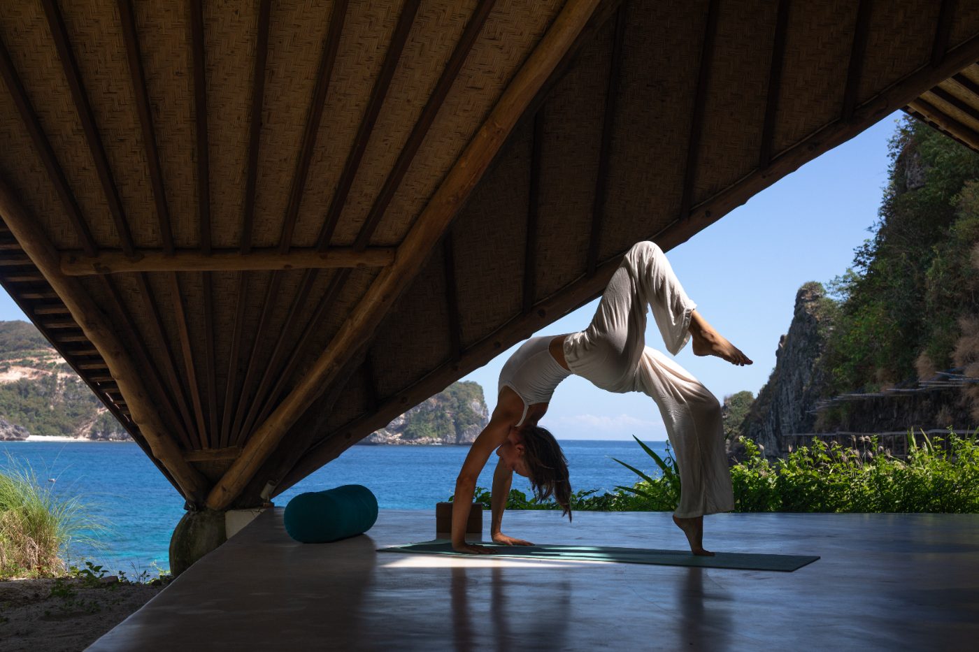 A yoga practice in an open bamboo pavilion above the ocean